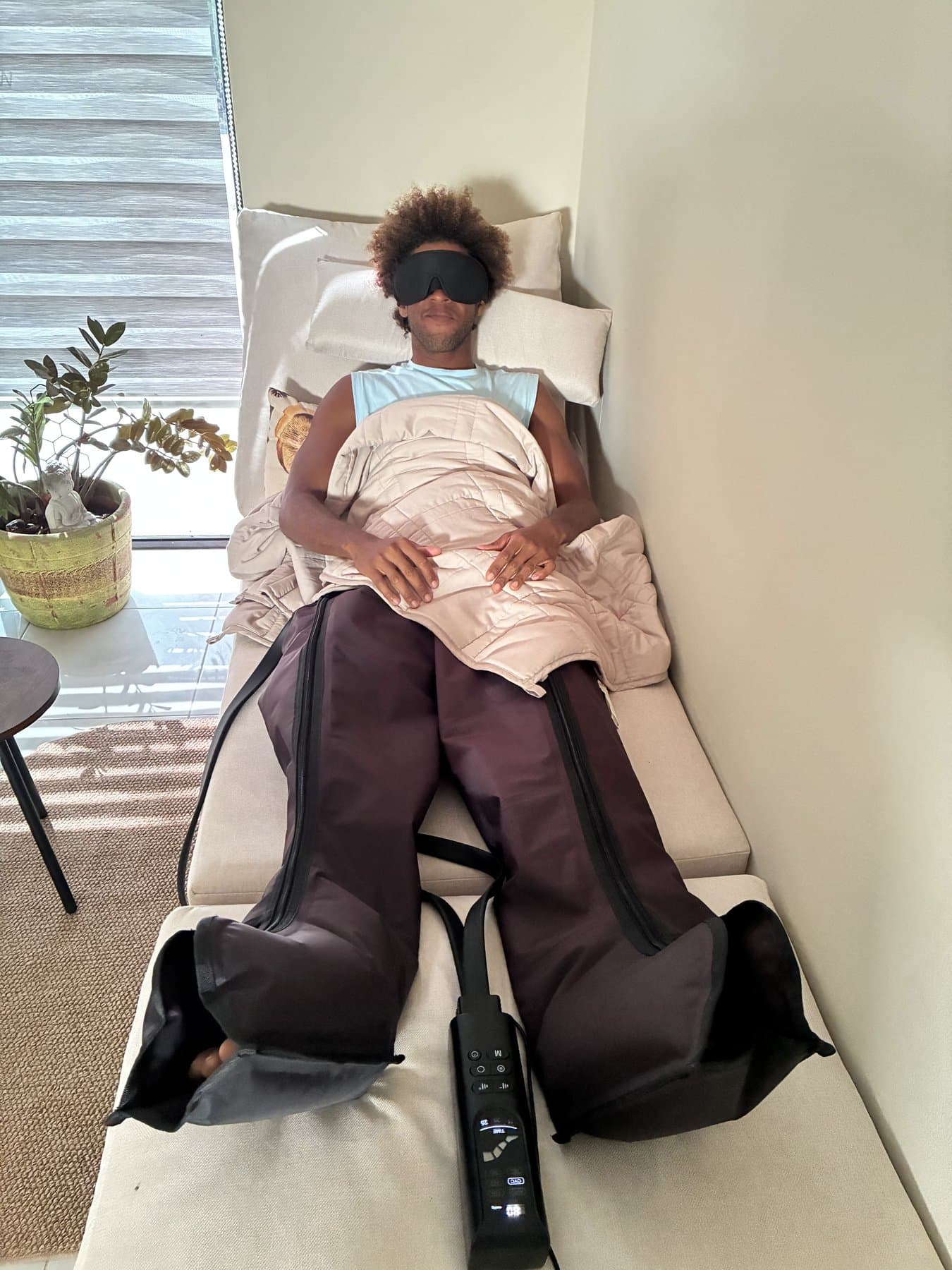 Client relaxing in compression boots.