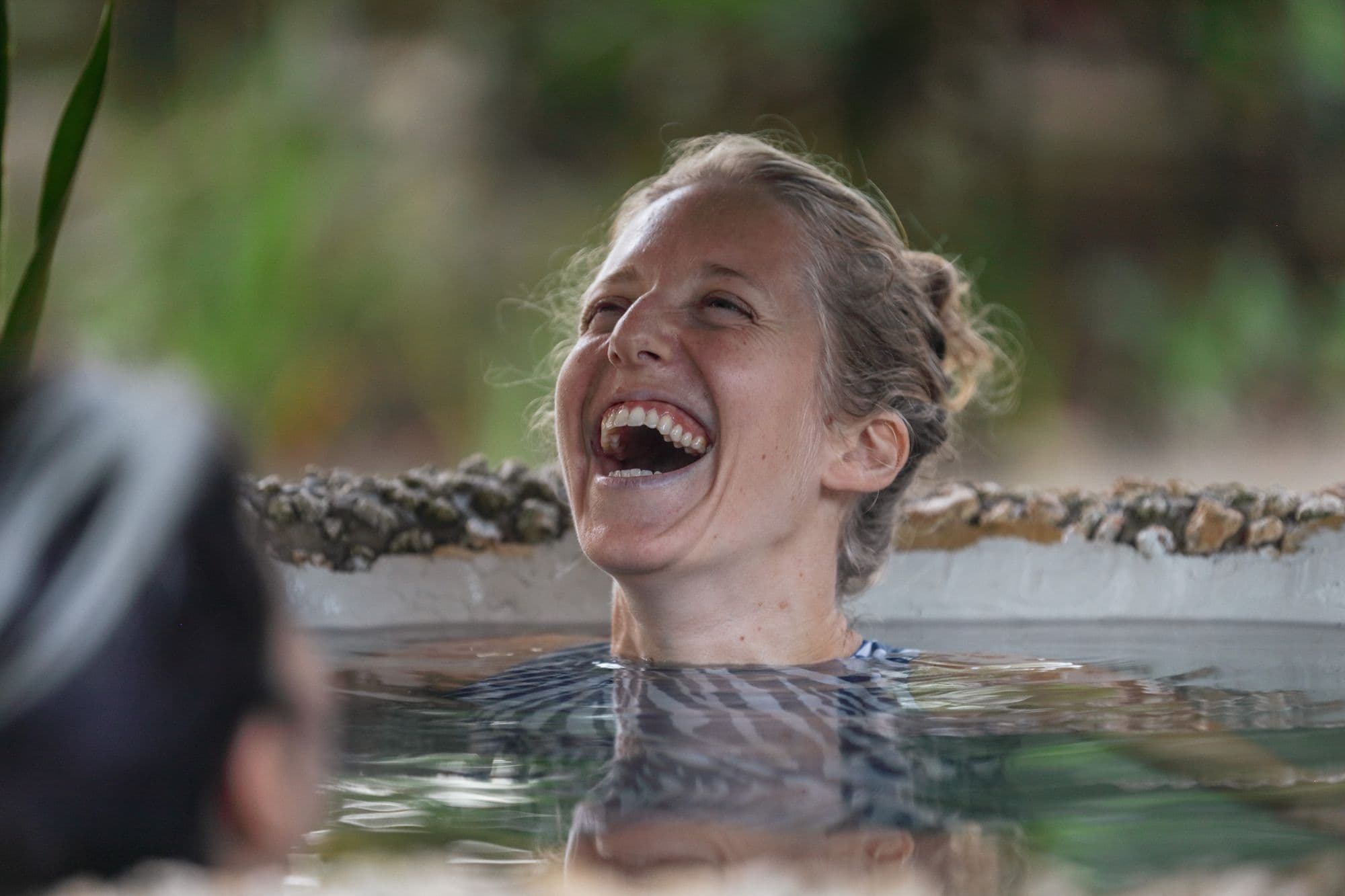Dasha Maximov laughing with her shoulders in the water.
